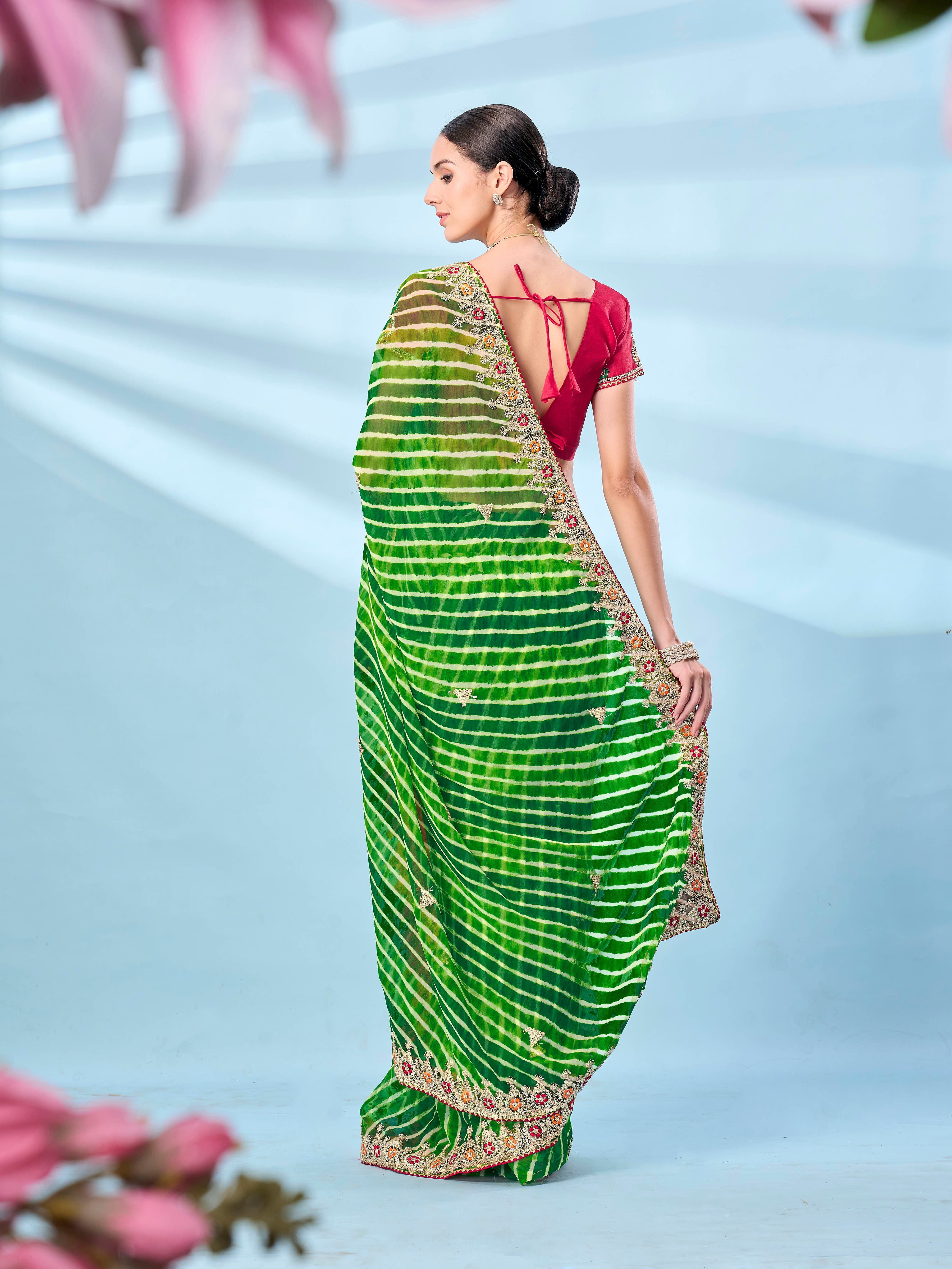 Green colored leheriya printed embroidered saree